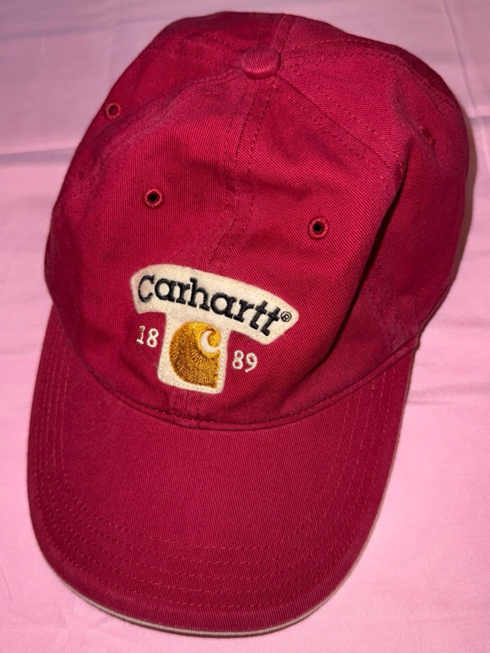 vintage Carhartt script logo strapback hat in a red/maroon colorway